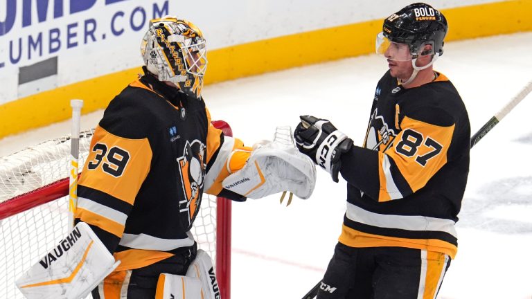 Pittsburgh Penguins' Sidney Crosby (87) celebrates with goalie Alex Nedeljkovic (39) after an NHL hockey game against the Edmonton Oilers in Pittsburgh, Thursday, Jan. 9, 2025. (Gene J. Puskar/AP)