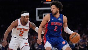 New York Knicks' Miles McBride (2) defends Detroit Pistons' Cade Cunningham (2) during the second half of an NBA basketball game, Monday, Jan. 13, 2025, in New York. (AP Photo/Frank Franklin II)