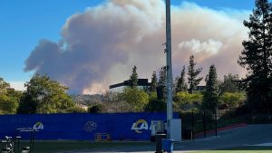 Smokes from a wildfire rises over the Los Angeles Rams NFL football practice facility in the Woodland Hills section of Los Angeles, Thursday, Jan. 9, 2025. (Greg Beacham/AP)