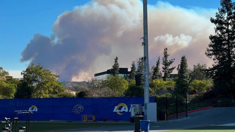 Smokes from a wildfire rises over the Los Angeles Rams NFL football practice facility in the Woodland Hills section of Los Angeles, Thursday, Jan. 9, 2025. (Greg Beacham/AP)