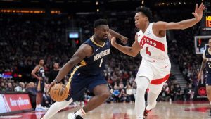 New Orleans Pelicans forward Zion Williamson (1) drives to the net past Toronto Raptors forward Scottie Barnes (4) during first half NBA basketball action in Toronto on Monday, January 27, 2025. (Nathan Denette/CP)