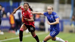 Manchester United's Jayde Riviere, left, and Chelsea's Guro Reiten battle for the ball during the Barclays Women's Super League match at Kingsmeadow, London, Sunday Nov. 24, 2024. Canadian fullback Riviere has signed a new contract with Manchester United that runs through June 2028, with an option of an additional year. (Zac Goodwin/PA via AP/CP)