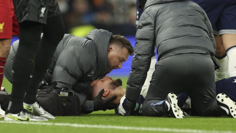 Tottenham's Rodrigo Bentancur receives medical treatment during the English League Cup semi final first leg soccer match between Tottenham and Liverpool, at the Tottenham Hotspur Stadium in London, Wednesday, Jan. 8, 2025. (Ian Walton/AP)