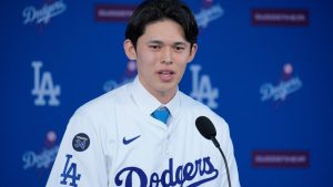 Japanese right-hander pitcher Roki Sasaki, 23, speaks as he is introduced by the Los Angeles Dodgers at a news conference at Dodger Stadium Wednesday, Jan. 22, 2025 in Los Angeles. (AP Photo/Damian Dovarganes)