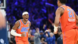 Oklahoma City Thunder guard Shai Gilgeous-Alexander, left, celebrates after guard Aaron Wiggins, right, made a basket during the second half of an NBA basketball game. (Kyle Phillips/AP)