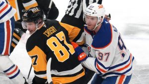 Pittsburgh Penguins' Sidney Crosby (87) and Edmonton Oilers' Connor McDavid (97) compete during the first period of an NHL hockey game in Pittsburgh, Thursday, Jan. 9, 2025. (Gene J. Puskar/AP)