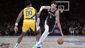 San Antonio Spurs center Victor Wembanyama (1) drives to the basket against Indiana Pacers guard Bennedict Mathurin (00) during the second half of a Paris Games 2025 NBA basketball game in Paris, Thursday, Jan. 23, 2025. (AP Photo/Thibault Camus)