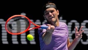 Taylor Fritz of the U.S. plays a forehand return to Jenson Brooksby of the U.S. during their first round match at the Australian Open tennis championship in Melbourne, Australia, Tuesday, Jan. 14, 2025. (AP Photo/Vincent Thian)