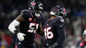 Houston Texans' Denico Autry (96) celebrates with Will Anderson Jr. (51) after sacking Los Angeles Chargers quarterback Justin Herbert during the second half of an NFL wild-card playoff football game Saturday, Jan. 11, 2025, in Houston. (Eric Christian Smith/AP)