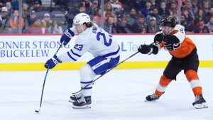 Toronto Maple Leafs' Matthew Knies, left, shoots the puck past Philadelphia Flyers' Jamie Drysdale during the first period of an NHL hockey game, Tuesday, Jan. 7, 2025, in Philadelphia. (Matt Slocum/AP)