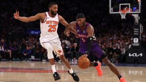 Toronto Raptors' Immanuel Quickley, right, dribbles the ball against New York Knicks' Mikal Bridges, left, during the first half of an NBA basketball game, Wednesday, Jan. 8, 2025, in New York. (Pamela Smith/AP)