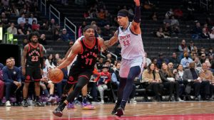 Toronto Raptors forward Bruce Brown (11) dribbles the ball to the hoop against Washington Wizards forward Kyle Kuzma (33) during the first half of an NBA basketball game Wednesday, Jan. 29, 2025, in Washington. (Jess Rapfogel/AP)