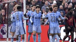 Tottenham Hotspur players celebrate an own goal from Tamworth's Nathan Tshikuna, second right, during the English FA Cup third round match at The Lamb Ground, Tamworth, England, Sunday Jan. 12, 2025. (Joe Giddens/PA via AP)