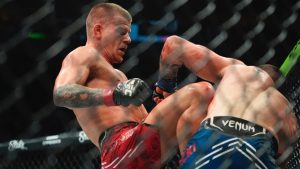 Grant Dawson, left, knees Joe Solecki during the third round of a UFC lightweight bout. (Frank Franklin II/AP)