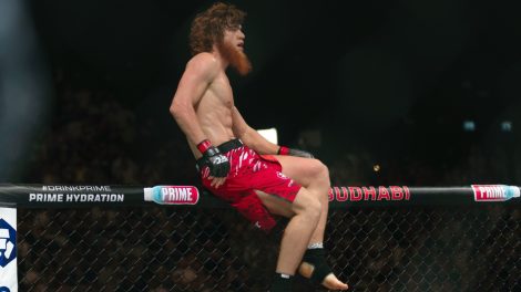 Shara-Magomedov,-climbs-on-the-cage-after-winning-a-UFC-middleweight-bout-in-Abu-Dhabi