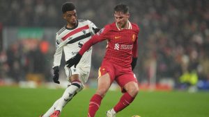 Liverpool's Alexis Mac Allister, right, and Manchester United's Amad Diallo fight for the ball during the English Premier League soccer match at the Anfield stadium in Liverpool, England, Sunday, Jan. 5, 2025. (Jon Super/AP)