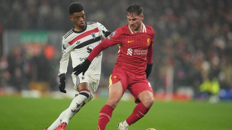 Liverpool's Alexis Mac Allister, right, and Manchester United's Amad Diallo fight for the ball during the English Premier League soccer match at the Anfield stadium in Liverpool, England, Sunday, Jan. 5, 2025. (Jon Super/AP)