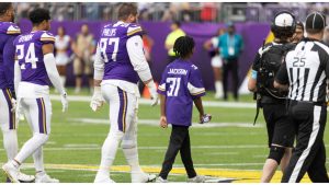 Former Minnesota Vikings rookie Khyree Jackson's brother Kolston Jackson (31) walks on the field for the coin toss with Minnesota Vikings defensive tackle Harrison Phillips (97) before an NFL preseason game against Saturday, Aug. 10, 2024. (AP Photo/Andy Clayton-King)