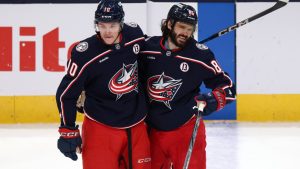 Columbus Blue Jackets forward Kirill Marchenko, right, celebrates his empty-net goal against the Seattle Kraken with teammate forward Dmitri Voronkov, left, during the third period of an NHL hockey game in Columbus, Ohio, Thursday, Jan. 9, 2025. (AP Photo/Paul Vernon)