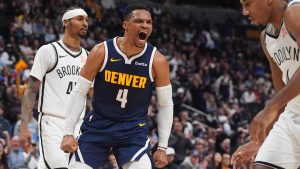 Denver Nuggets guard Russell Westbrook (4) reacts after dunking the ball for a basket as Brooklyn Nets guards Keon Johnson, left, and Reece Beekman look on in the second half of an NBA basketball game Friday, Jan. 10, 2025, in Denver. (David Zalubowski/AP)