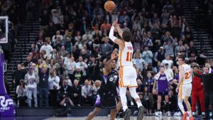 Atlanta Hawks guard Trae Young (11) shoots a three point shot from half court over Utah Jazz guard Collin Sexton (2) at the buzzer to win an NBA basketball game, Tuesday, Jan. 7, 2025, in Salt Lake City. (Rob Gray/AP)