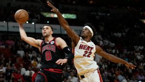 Chicago Bulls guard Zach LaVine (8) shoots over Miami Heat forward Jimmy Butler (22) during the first half of an NBA basketball game, Sunday, Dec. 8, 2019, in Miami. (AP Photo/Lynne Sladky)