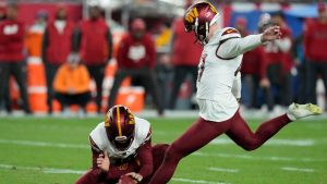 Washington Commanders place kicker Zane Gonzalez, right, kicks the game winning field goal from the hold of Tress Way during the second half of an NFL wild-card playoff football game against the Tampa Bay Buccaneers in Tampa, Fla., Sunday, Jan. 12, 2025. (Chris O'Meara/AP)