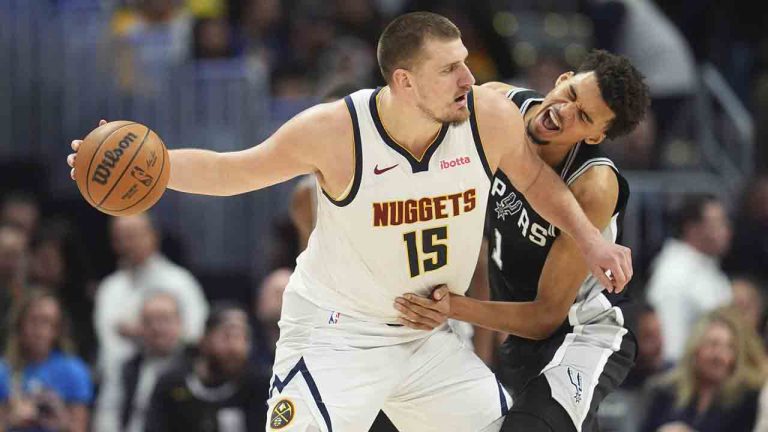 Denver Nuggets center Nikola Jokic, looks to pass the ball as San Antonio Spurs center Victor Wembanyama defends in the second half of an NBA basketball game Friday, Jan. 3, 2025, in Denver. (David Zalubowski/AP)