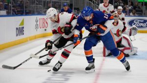 New York Islanders' Mathew Barzal (13) fights for control of the puck with Ottawa Senators' Artem Zub (2) during the second period of an NHL hockey game, Tuesday, Jan. 14, 2025, in Elmont, N.Y. (Frank Franklin II/AP)