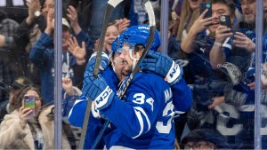 Toronto Maple Leafs defenceman Morgan Rielly (44) celebrates his game-winning overtime goal with centre Auston Matthews (34) during NHL hockey action against the Philadelphia Flyers, in Toronto, Sunday, Jan. 5, 2025. (Frank Gunn/CP)