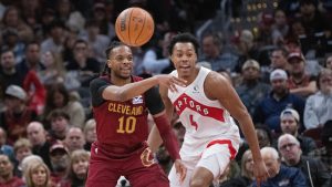 Cleveland Cavaliers' Darius Garland (10) passes the ball as Toronto Raptors' Scottie Barnes (4) defends during the first half of an NBA basketball game in Cleveland, Thursday, Jan. 9, 2025. (Phil Long/AP Photo)