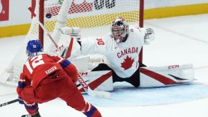 Czechia forward Eduard Sale (12) scores on Canada goalkeeper Carter George (30) during first period IIHF World Junior Hockey Championship quarterfinal action in Ottawa, Thursday, Jan. 2, 2025. (Adrian Wyld/CP)