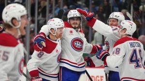 Montreal Canadiens centre Kirby Dach, second from left, is congratulated after scoring the winning goal by, from left, defenseman Mike Matheson, left wing Emil Heineman and defenceman Lane Hutson after a shootout victory over the Colorado Avalanche in an NHL hockey game Saturday, Jan. 4, 2025, in Denver. (David Zalubowski/AP)