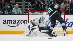 Vancouver Canucks goaltender Kevin Lankinen makes a save against Seattle Kraken center Matty Beniers (10) during a shootout for a 4-3 Canucks win in an NHL hockey game Thursday, Jan. 2, 2025, in Seattle. (Lindsey Wasson/AP)