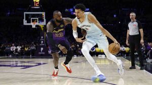 San Antonio Spurs centre Victor Wembanyama, right, drives to the basket against Los Angeles Lakers forward LeBron James (23) during the first quarter of an NBA basketball game Monday, Jan. 13, 2025, in Los Angeles. (Kevork Djansezian/AP)