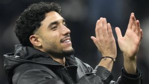 Omar Marmoush greets fans after the German Bundesliga soccer match between Eintracht Frankfurt and Borussia Dortmund. (AP Photo/Michael Probst)