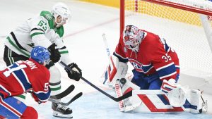 Dallas Stars' Evgenii Dadonov (63) moves in on Montreal Canadiens goaltender Sam Montembeault (35) as Canadiens' Emil Heineman (51) defends during third period NHL hockey action in Montreal, Saturday, January 11, 2025. (Graham Hughes/CP)