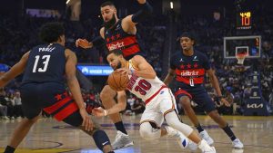 Golden State Warriors' Stephen Curry (30) attempts to drive past Washington Wizards' Jordan Poole (13) in the first quarter of an NBA basketball game in San Francisco, Saturday, Jan. 18, 2025. (Jose Carlos Fajardo/Bay Area News Group via AP)