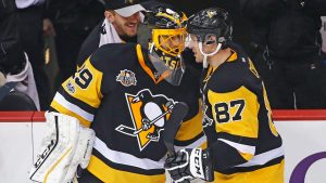 Pittsburgh Penguins' Sidney Crosby (87) celebrates with goalie Marc-Andre Fleury (29) after Crosby had an assist for the 1,000th point of his NHL career, during the first period of an NHL hockey game against the Winnipeg Jets in Pittsburgh, Thursday, Feb. 16, 2017. (Gene J. Puskar/AP)