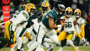 Philadelphia Eagles quarterback Jalen Hurts (1) runs with the ball during the first half of an NFL wild-card playoff football game against the Green Bay Packers on Sunday, Jan. 12, 2025, in Philadelphia. (Derik Hamilton/AP)