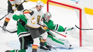 Dallas Stars goaltender Jake Oettinger, back right, gloves a shot by Vegas Golden Knights left wing Pavel Dorofeyev, not visible, in the final minute of the third period of an NHL game Friday, Jan. 24, 2025, in Dallas. (Julio Cortez/AP)