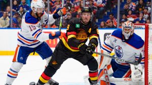 J.T. Miller #9 of the Vancouver Canucks screens Stuart Skinner #74 of the Edmonton Oilers during the second period of their NHL game at Rogers Arena on January 18, 2025 in Vancouver, British Columbia, Canada. (Photo by Jeff Vinnick/NHLI via Getty Images)