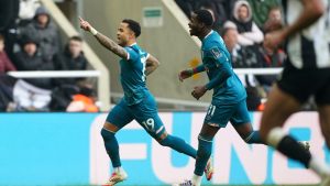 Bournemouth's Justin Kluivert, left, celebrates after scoring his side's third goal during the English Premier League soccer match between Newcastle United and AFC Bournemouth in Newcastle upon Tyne, England, Saturday, Jan. 18, 2025. (Owen Humphreys/PA via AP)