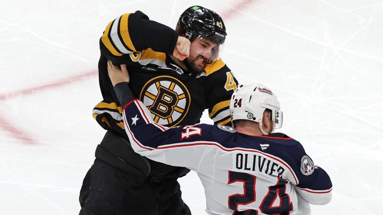 Boston Bruins forward Mark Kastelic (47) and Columbus Blue Jackets' Mathieu Olivier (24) fight during the first period of an NHL hockey game Saturday, Dec. 28, 2024, in Boston. (Jim Davis/AP Photo)