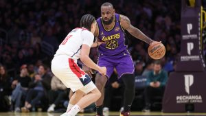 Los Angeles Lakers forward LeBron James (23) dribbles against Washington Wizards forward Kyshawn George (18) during the first half on an NBA basketball game Tuesday, Jan. 21, 2025, in Los Angeles. (Raul Romero Jr./AP)