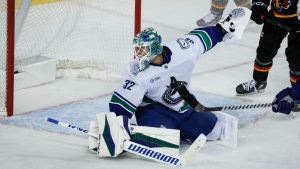 Vancouver Canucks goalie Kevin Lankinen lets in a goal during the third period of an NHL hockey game against the Calgary Flames in Calgary on Tuesday, Dec. 31, 2024. (Jeff McIntosh/CP)