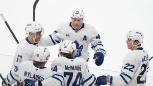 Toronto Maple Leafs' Bobby McMann (74) celebrates his goal over the Montreal Canadiens with teammates from left to right Max Domi (11), William Nylander (88), Morgan Rielly (44) and Jake McCabe (22) during second period NHL hockey action in Montreal on Saturday, Jan. 18, 2025. (Christinne Muschi/THE CANADIAN PRESS)