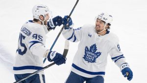 Toronto Maple Leafs' Oliver Ekman-Larsson (95) celebrates his goal over the Montreal Canadiens with teammate Toronto Maple Leafs' Nicholas Robertson (89) during third period NHL hockey action in Montreal on Saturday, Jan.18, 2025. (Christinne Muschi/CP)