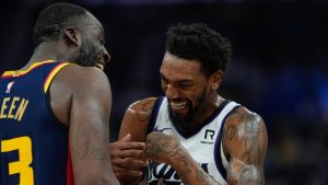 Golden State Warriors forward Draymond Green, left, laughs with Sacramento Kings guard Malik Monk, right, during the first half of an NBA basketball game Sunday, Jan. 5, 2025, in San Francisco. (Godofredo A. Vásquez/AP)