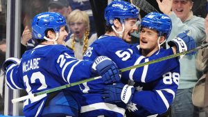 Toronto Maple Leafs' William Nylander (right) celebrates his game-winning goal against the New Jersey Devils with Jake McCabe (22) and Philippe Myers (51) during overtime NHL hockey action in Toronto on Thursday, January 16, 2025. (Frank Gunn/CP)